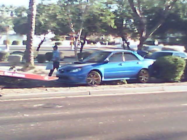 wrx or sti with gold wheels that got on it around a turn and spun out